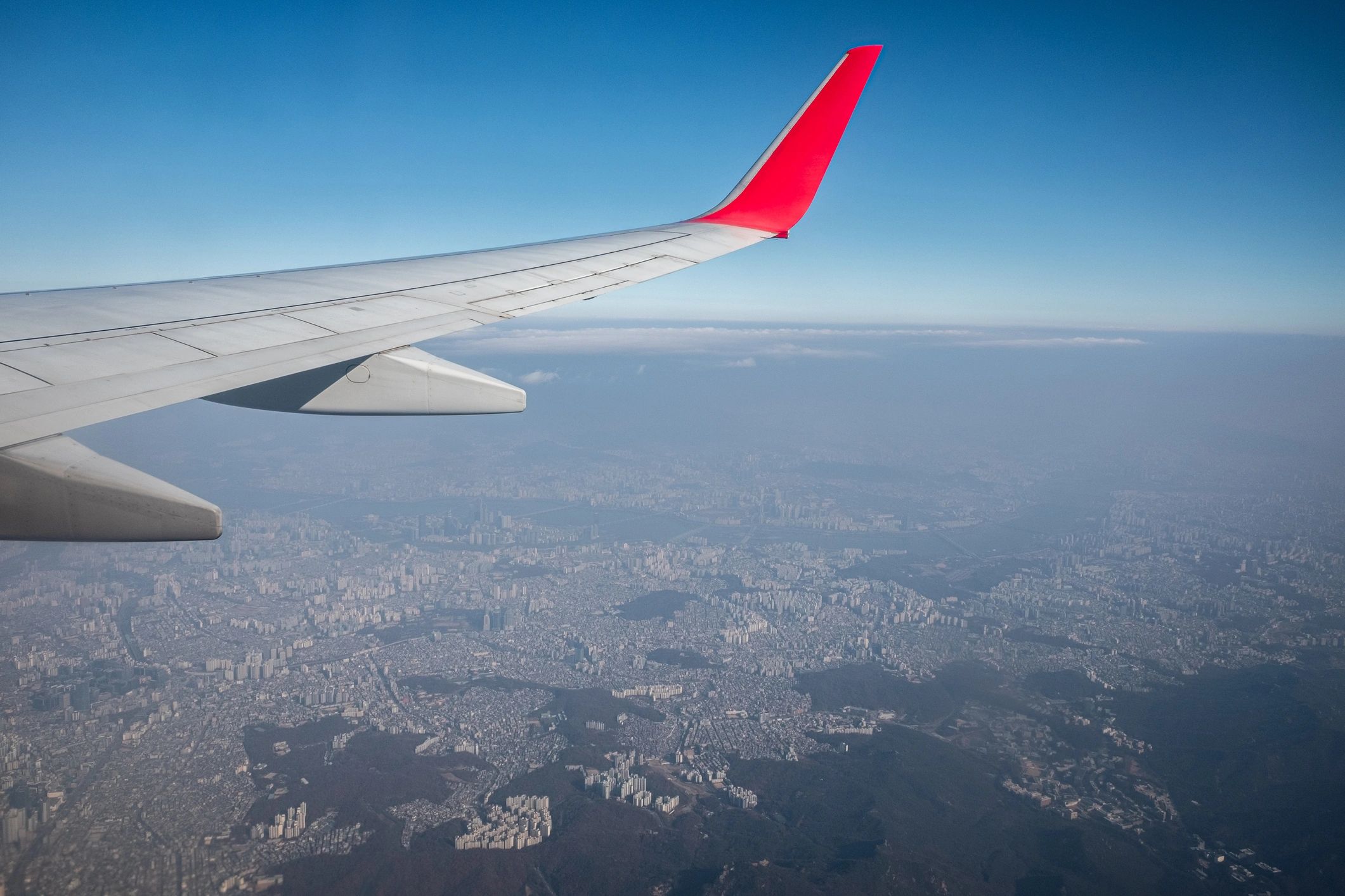 View of Seoul from an airplane window, representing travel to Korea.